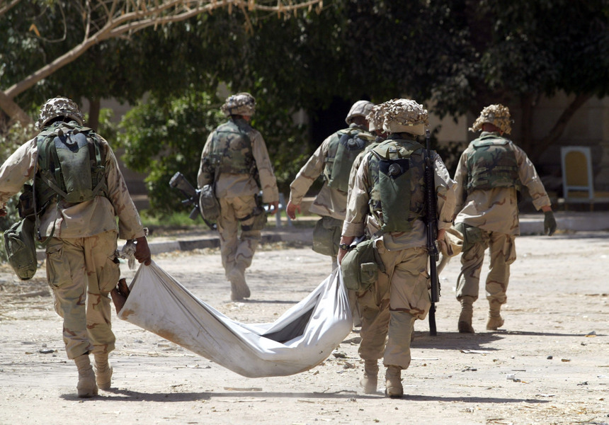 US Marines carry the bodies of Iraqis killed at a roadblock in Baghdad. © 2003 Mark Avery/Orange County Register