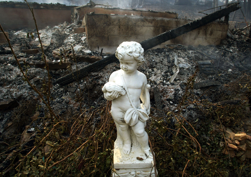 A statue stands untouched in front of a house that burned to the ground in the community of Kentwood, during wild fires in San Diego County near Julian.  © 2003 Mark Avery/Orange County Register